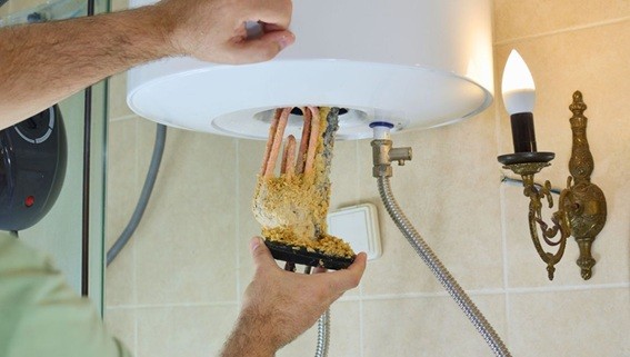 Electric water-heater element removed with scale buildup